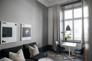 a living room with a couch and a table and a window at Guldgränd in Stockholm