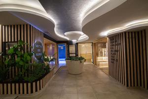 a hallway with plants and ceilings in a building at Apartman Borova Oaza in Zlatibor