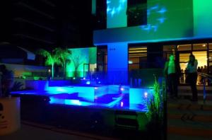 a building with blue and green lights in front of it at Flat Novo1 - Café, Cama Queen, Ar, Estac e Internet in Barueri