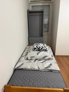 a bed in a small room with a bed frame at YCZ Praha in Prague +4 photos