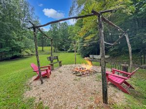 two red benches sitting next to a fire pit at JME Retreat in Colwell