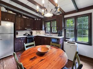 a kitchen with a wooden table and a refrigerator at JME Retreat in Colwell