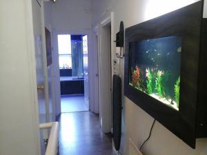 a living room with a fish aquarium on a wall at Heavenly Nights Guest House in Sheffield