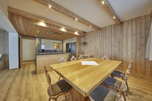 a dining room with a wooden table and chairs at Chalet Almglück by we rent, JOKERCARD INCLUDED in Saalbach-Hinterglemm