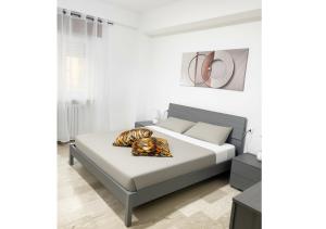 a white bedroom with a bed with white sheets at Chic house in Avezzano