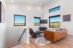a living room with a couch and a chair at Basecamp Stays: Teton Views Huge Deck Stargazing in Alta