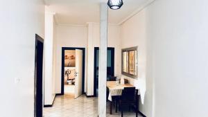 a dining room with a table and chairs in a room at Tulivu Rëcc in Nditarh +15 photos