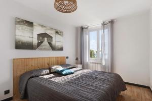 a bedroom with a bed and a large window at Gli Ulivi in Bogliasco