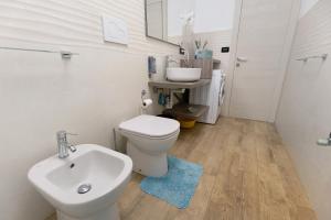 a bathroom with a white toilet and a sink at Gli Ulivi in Bogliasco +17 photos