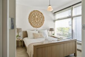 a bedroom with a large bed and a large window at Appartement De Kokkel Free Parking in Zandvoort