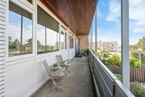 a balcony with chairs and windows on a building at Appartement De Kokkel Free Parking in Zandvoort
