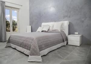 a bedroom with a large bed with white pillows at Villa Eden in Castiglione di Sicilia +13 photos