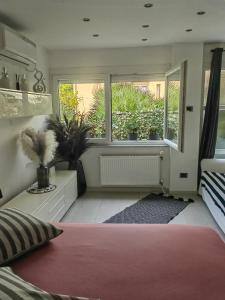 a bedroom with a window with potted plants at Studio Koper in Koper