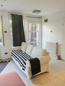 a white couch in a living room with a window at Studio Koper in Koper +2 photos
