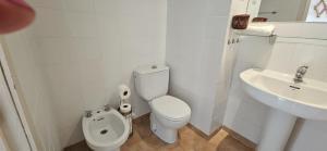 a white bathroom with a toilet and a sink at Centrico piso en Marbella in Marbella +19 photos