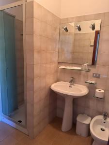 a bathroom with a sink and a shower at Albergo Il Tegolo in Cerreto Guidi +33 photos