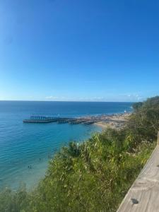 a view of a beach with a pier in the water at Welcome to Casa Girasol! in Rincon +11 photos
