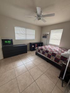 a bedroom with a bed and a ceiling fan at Lake Front Entire Home FL Getaway in Deltona
