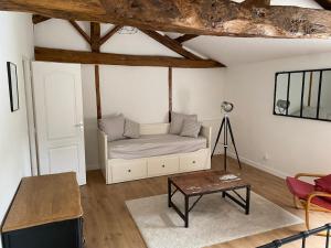 a living room with a couch and a table at Grande maison familiale avec piscine, 14 à 17 pers in Luçon +21 photos