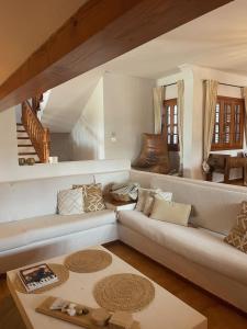 a living room with a couch and a table at Authentic Villa with amazing pool in Santa Gertrudis de Fruitera