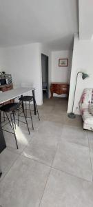Habitación con mesa, sillas y lámpara. en La cigala, en Le Pradet