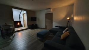 a living room with a couch and a table at Appartement neuf avec extérieur de plein pieds in Levie +4 photos