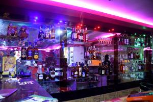 a bar filled with lots of bottles of alcohol at Hotel New Jasmine in Cuttack +5 photos