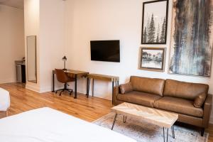 a living room with a couch and a table at The 3one3 Boutique Hotel in Alma