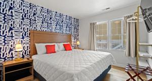a bedroom with a bed and a blue and white wall at Cabana Beach 4 Bright 2BR Condo Steps from the Sand in Myrtle Beach +22 photos