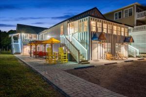 a building with tables and chairs in front of it at 2 bedroom Condo Steps from Beach Pet Friendly in Myrtle Beach