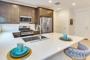a kitchen with a sink and a counter with blue dishes on it at Lake and Mtn Views Modern Apache Junction Getaway in Trails West Mobile Home Park