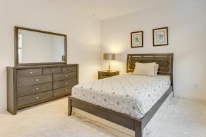 a bedroom with a bed and a dresser and a mirror at Lake and Mtn Views Modern Apache Junction Getaway in Trails West Mobile Home Park