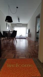 a living room with a table and chairs and a rug at Cálido y luminoso semipiso en Parque Chacabuco in Buenos Aires