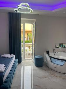 a bathroom with a bed and a tub and a sink at La Romantique Rooms and Apartments TROPEA in Parghelia