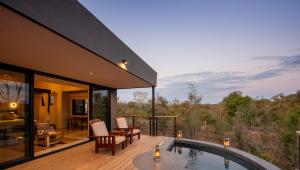 a house with a swimming pool on a deck at Idube Game Reserve in Sabi Sand Game Reserve