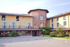 a group of buildings on a street at Hotel Villa Glicini in Pinerolo