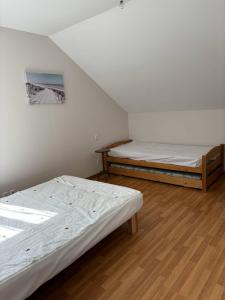 two beds are in a room with a attic at Le bourg 2 in Mimizan