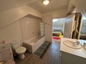 a bathroom with a sink and a toilet and a tub at Le bourg 2 in Mimizan +5 photos