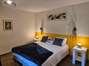 a bedroom with a large bed with two tables at Domaine de la Tardoire in Oradour-sur-Vayres