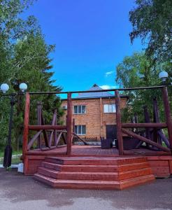 にあるБаза отдыхаの建物の前に階段がある大きな木造建築物