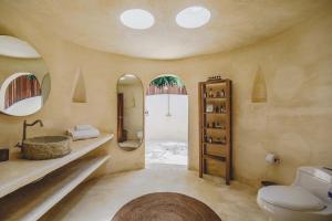 a bathroom with a sink and a toilet and mirrors at ONE Santuario Natural in Palomino
