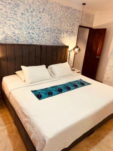 a bedroom with a bed with blue flowers on it at Hotel Marie Real Cartagena in Cartagena de Indias