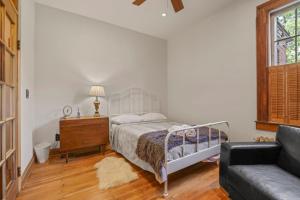 um quarto com uma cama, uma cómoda e um sofá em Spacious Historic 8-Bedroom Manor in Short North - Perfect for Large Groups em Milo