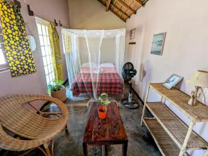 a room with a bed and a table in a room at Kulenga Village in Monkey Bay