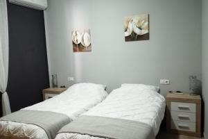 two beds sitting next to each other in a bedroom at Villa - Sleeps 4 - Pool - Patio - Parking in Arboleas +25 photos