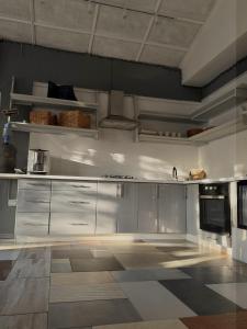 a large kitchen with white cabinets and appliances at Заміський комплекс Wognishe in Orlovshchina