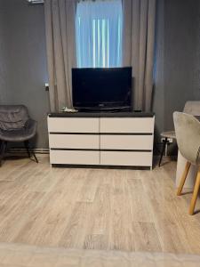 a living room with a television on a dresser at Заміський комплекс Wognishe in Orlovshchina +47 photos