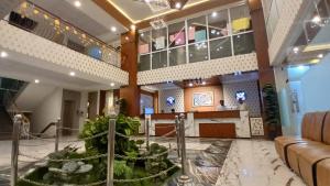 a lobby of a hotel with a fountain at Bridge Residency in Muzaffarabad