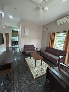 a living room with two couches and a table at Dviewhomestay in Jitra