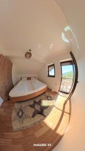 a bedroom with a bed in a round room at Beloviski raj 